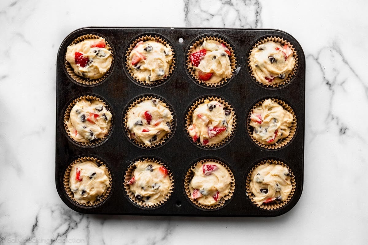 strawberry chocolate chip muffin batter in muffin pan