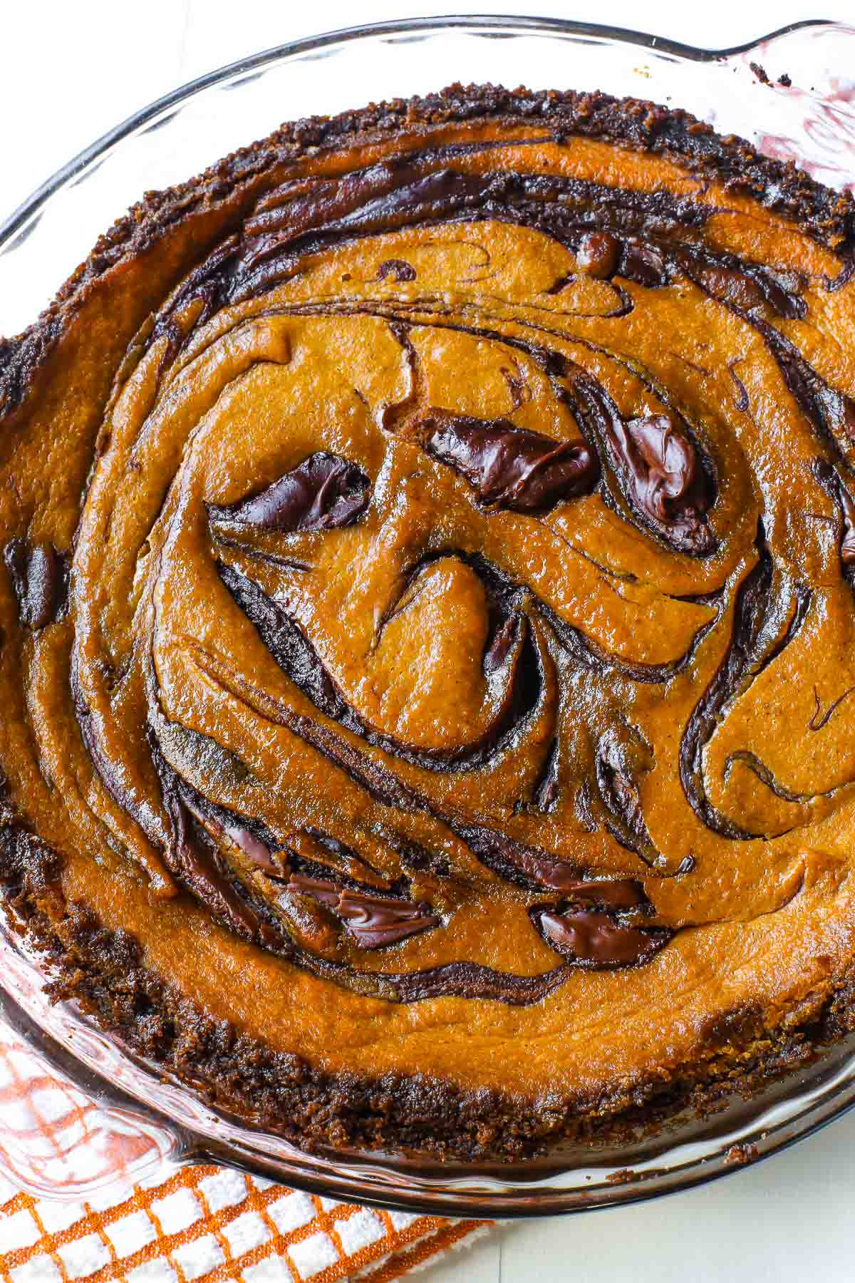 Nutella swirled pumpkin pie in a glass baking dish
