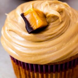 caramel cupcakes topped with salted caramel frosting and caramel candies