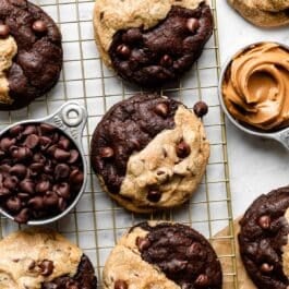 gold cooling rack with peanut butter chocolate swirl cookies on top.