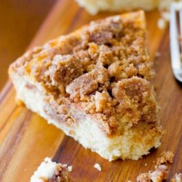 slice of super crumb coffee cake on a wood board