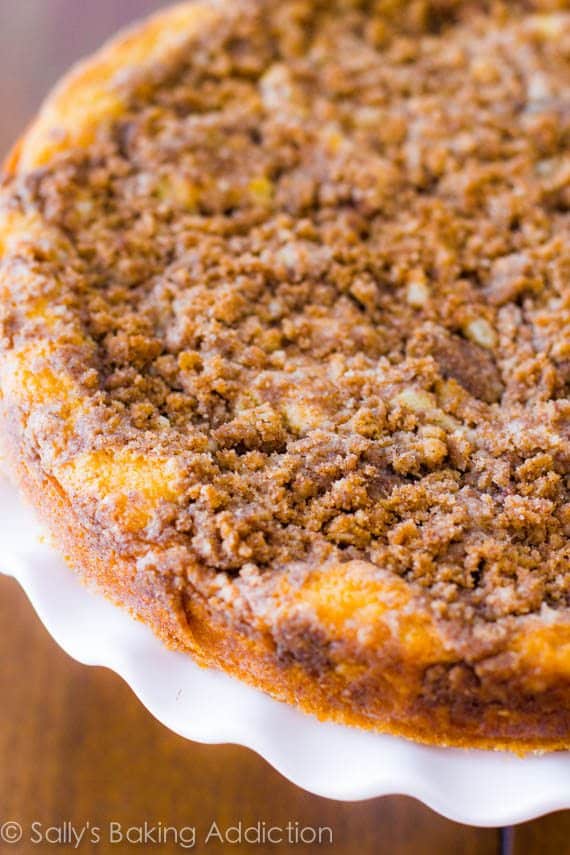 super crumb coffee cake on a white cake stand