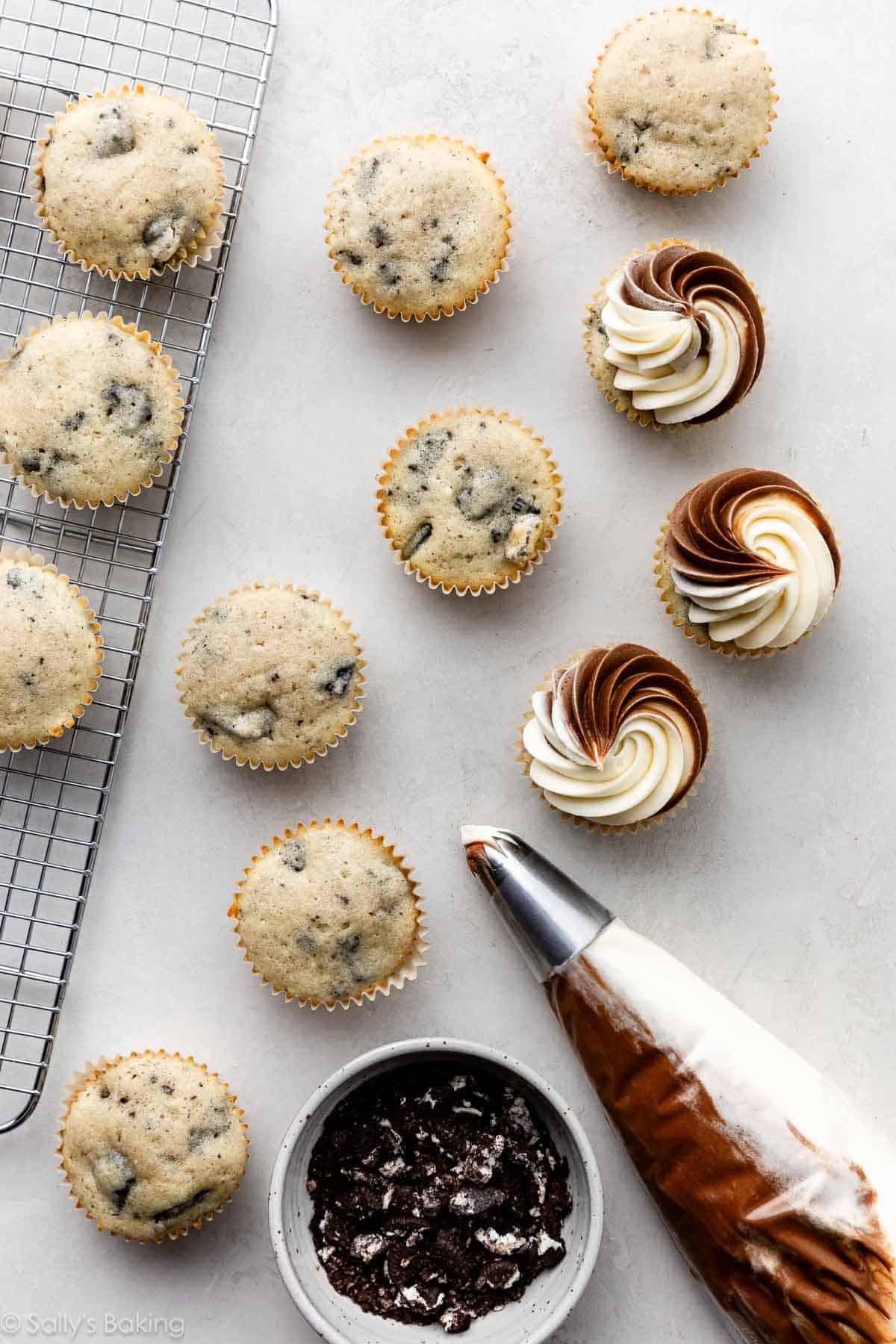 Oreo cupcakes with a piping bag with both chocolate and vanilla buttercream inside.