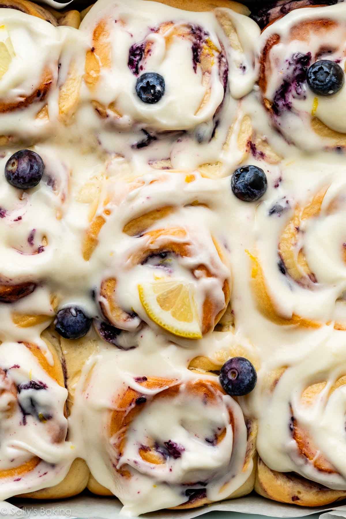 blueberry lemon sweet rolls with cream cheese icing on top.