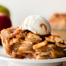 salted caramel apple pie slice with vanilla ice cream on top.