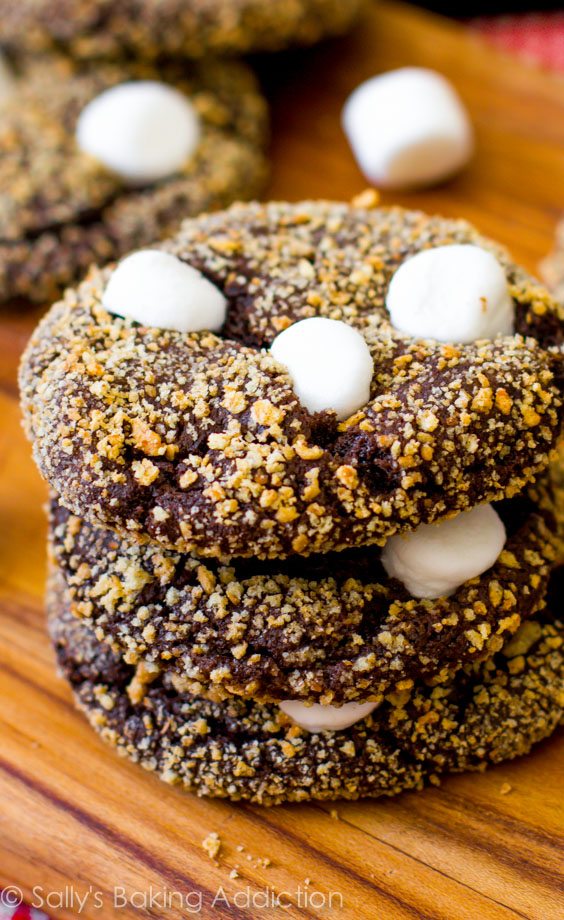 stack of s'mores chocolate crinkle cookies on a wood board