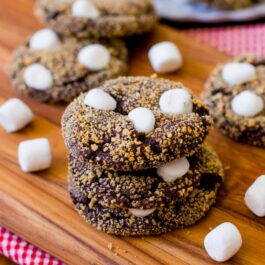 stack of s'mores chocolate crinkle cookies on a wood board