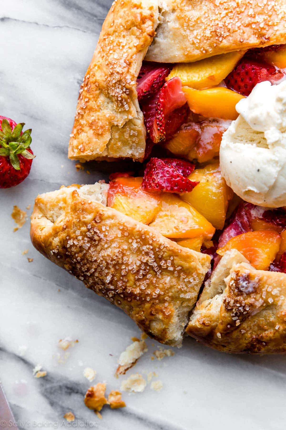 cut slice of strawberry peach galette tart