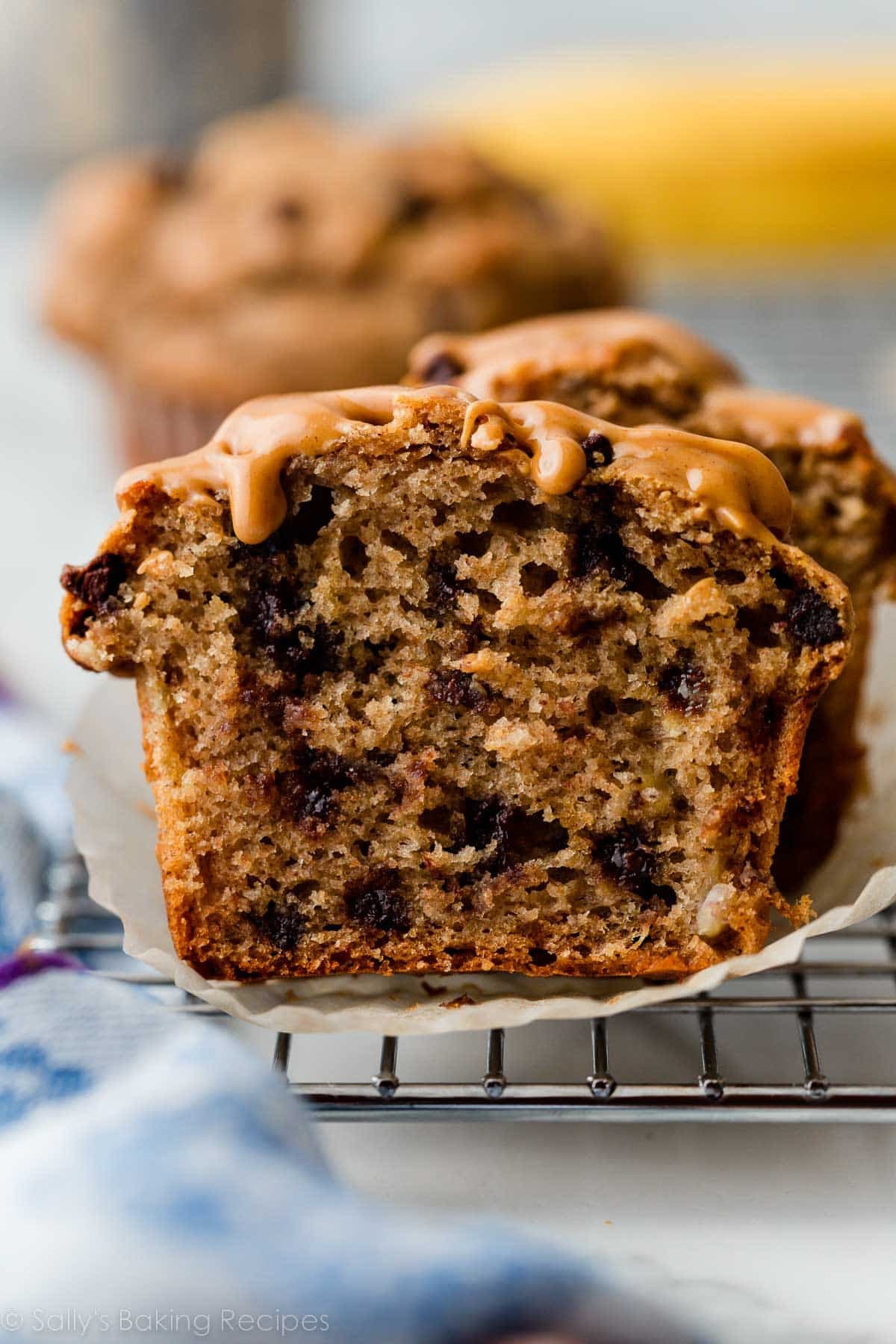 healthier peanut butter banana muffin with mini chocolate chips cut in half.
