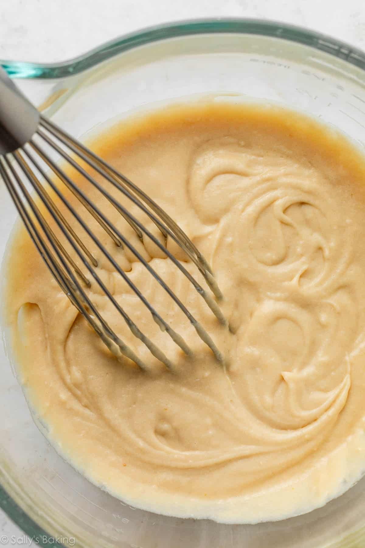 whisk and batter in a glass bowl.