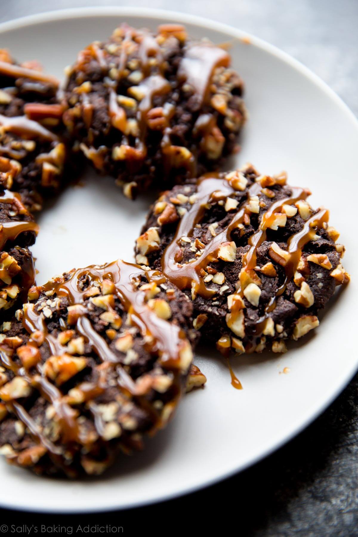 chocolate turtle cookies on a white plate