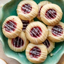 raspberry almond thumbprints on blue plate.