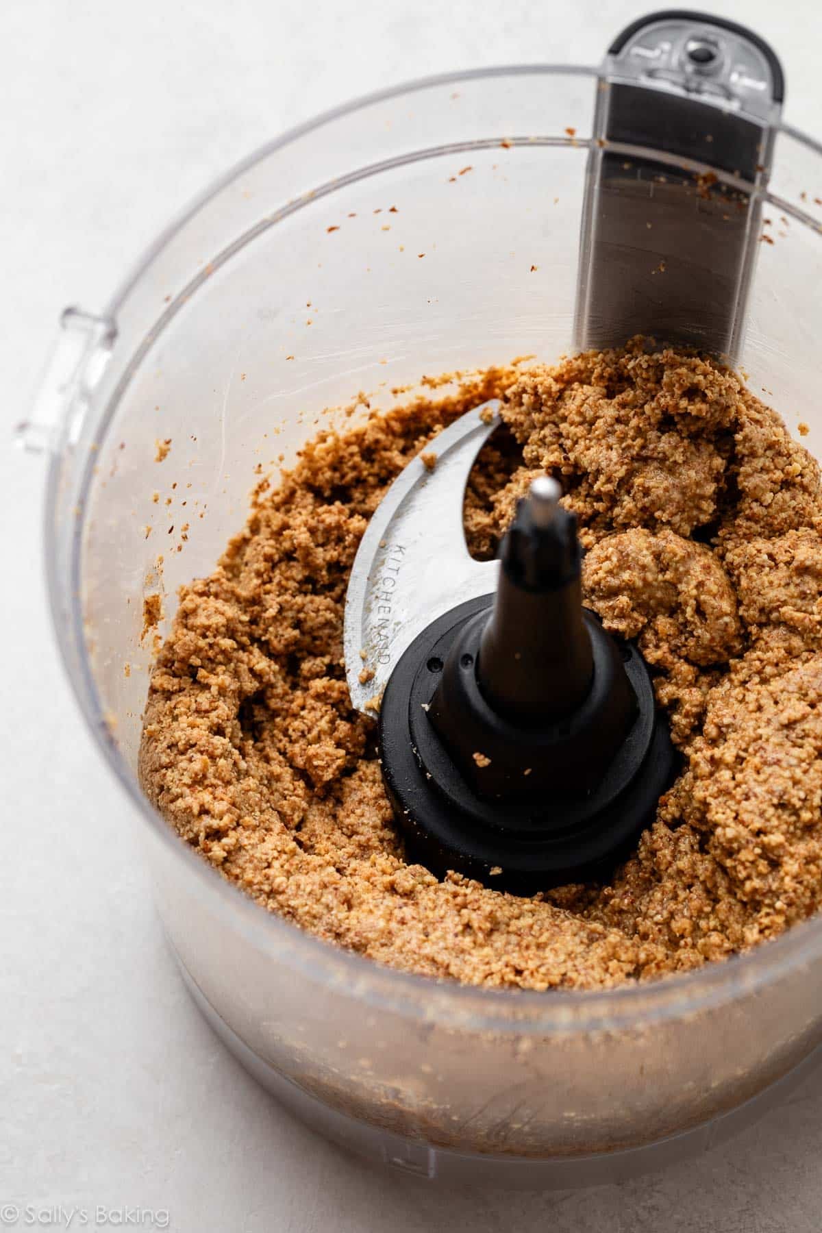showing a stage of pulsed/pureed almonds in food processor.