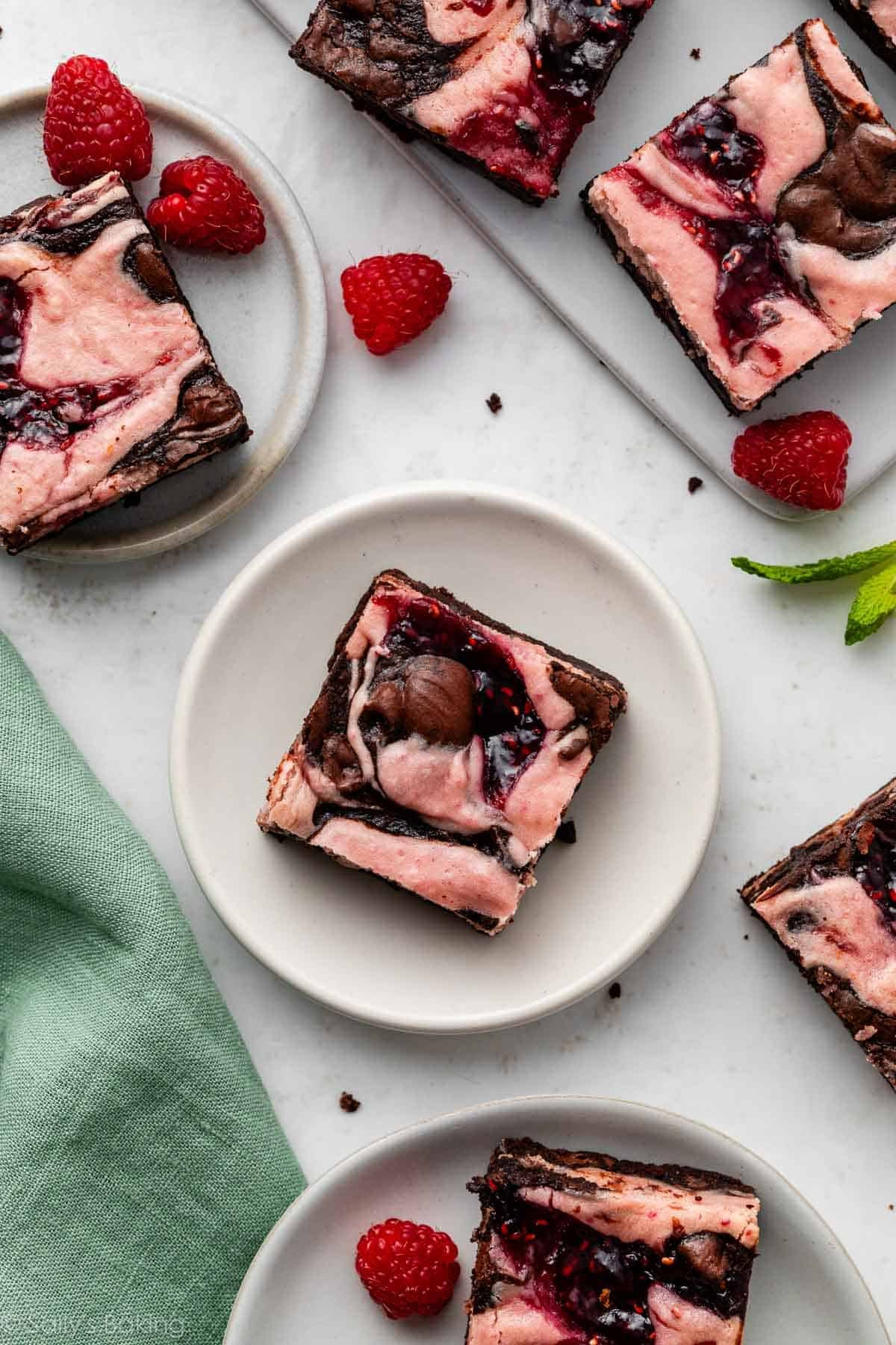 raspberry cheesecake swirl brownies on plates.