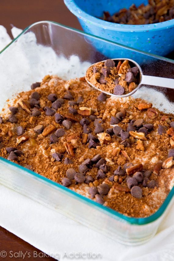 crumb cake streusel on top of banana crumb cake batter in a glass baking dish