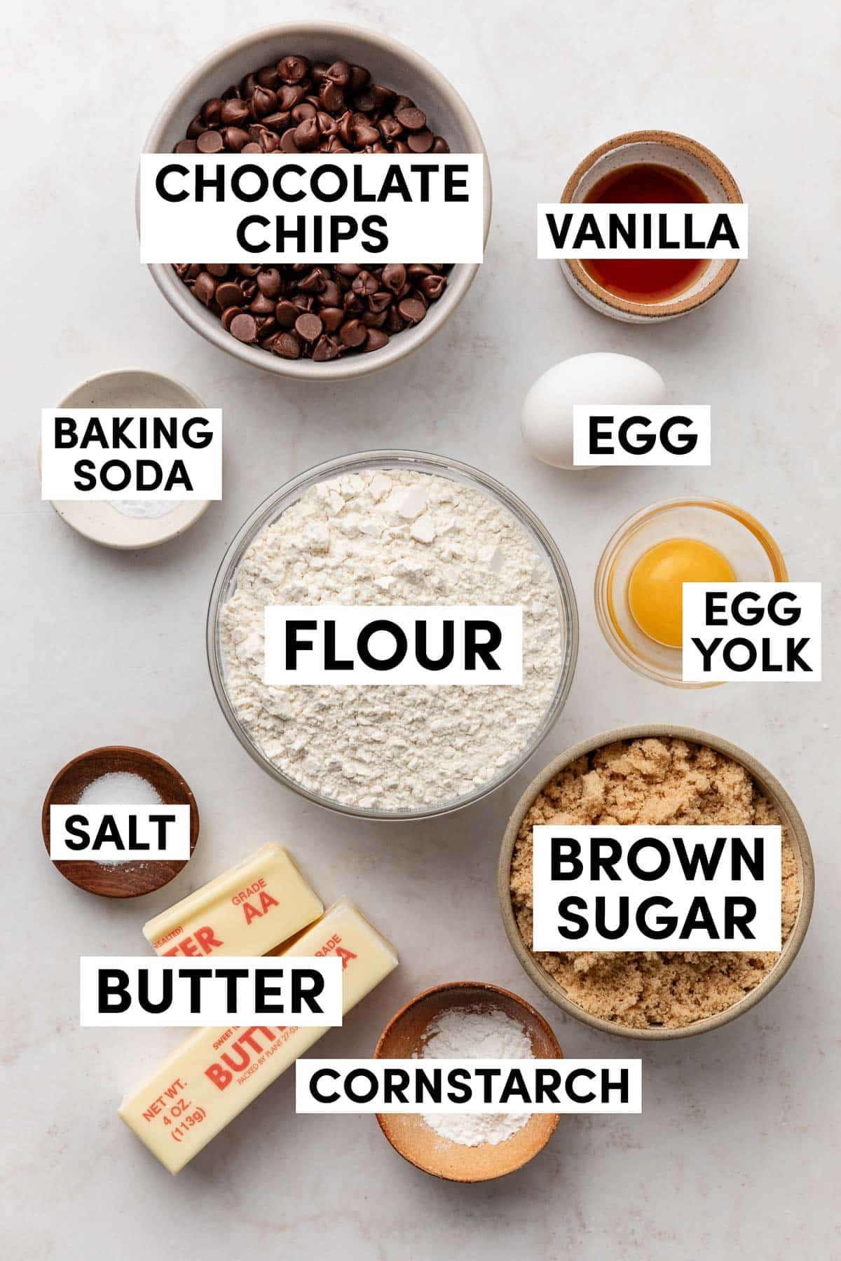 ingredients measured in bowls including flour, brown sugar, cornstarch, egg yolk, vanilla, salt, and baking soda.