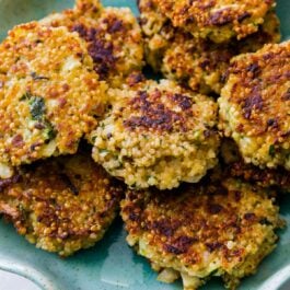 quinoa patties on a teal plate