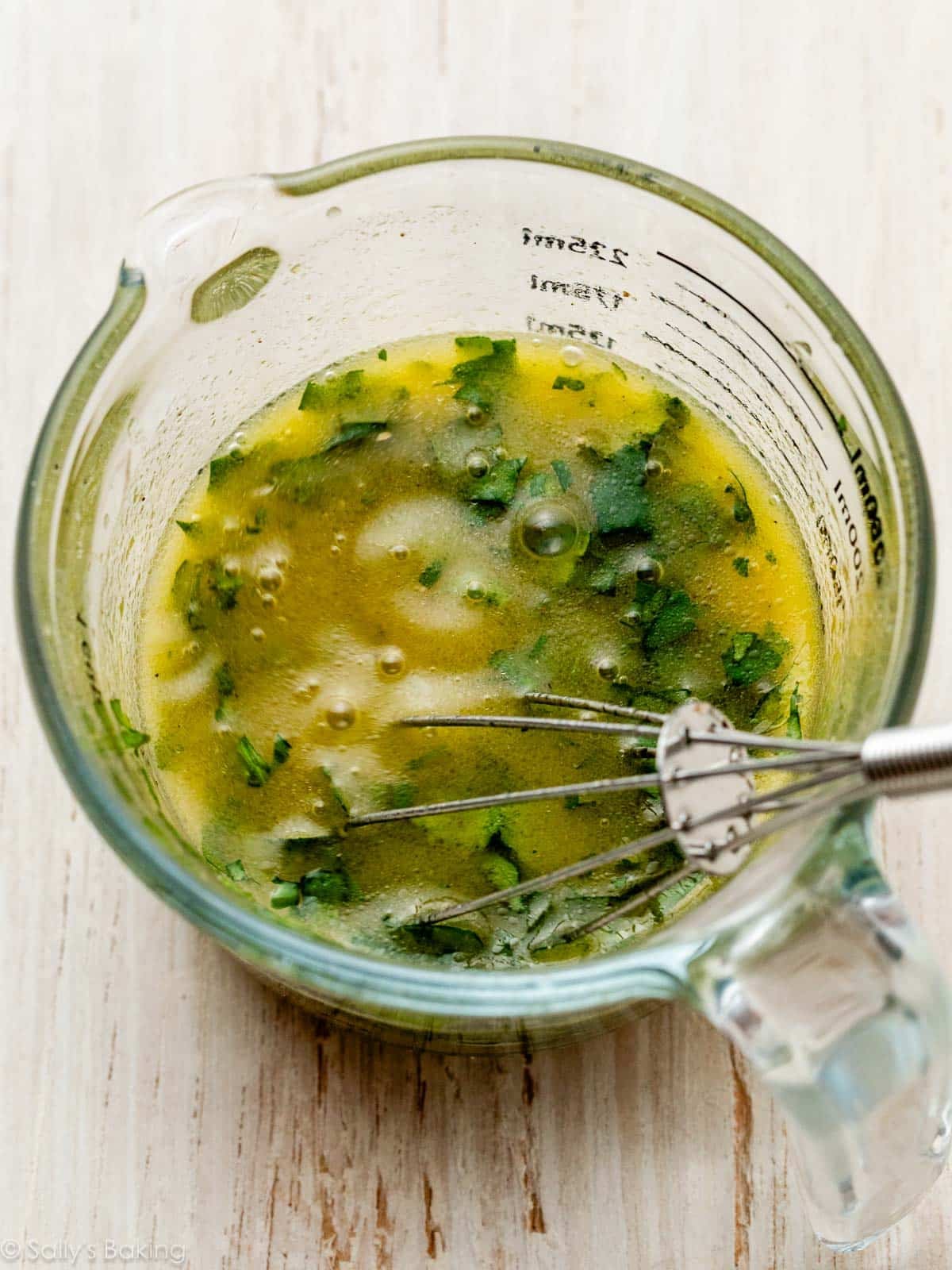 cilantro dressing in measuring cup.