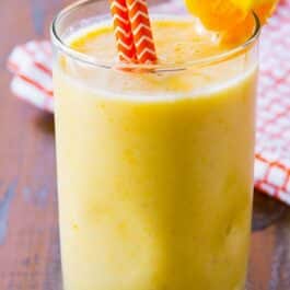 creamsicle smoothie in a glass with straws