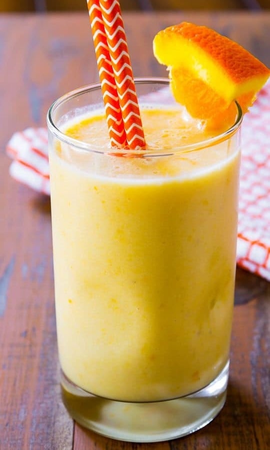 creamsicle smoothie in a glass with straws