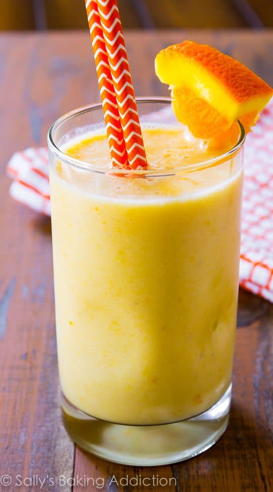 creamsicle smoothie in a glass with straws