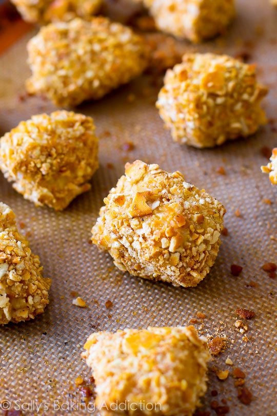 pretzel crusted chicken bites on a silpat baking mat