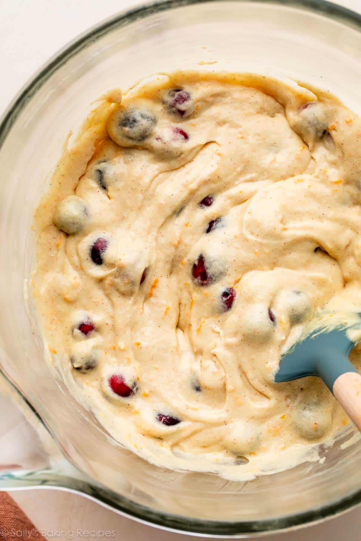 batter with cranberries in glass bowl.