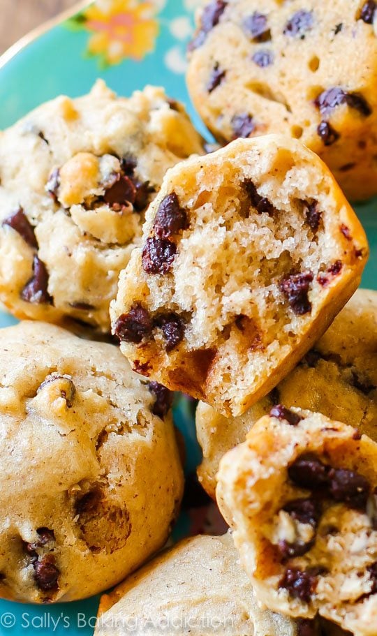 mini chocolate chip muffins with a bite taken from one showing the inside