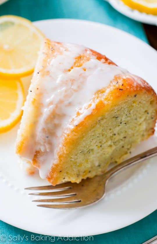 slice of lemon poppy seed bundt cake on a white plate with a fork