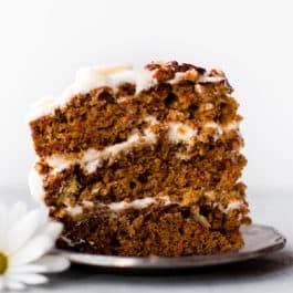 slice of carrot cake with cream cheese frosting on a plate