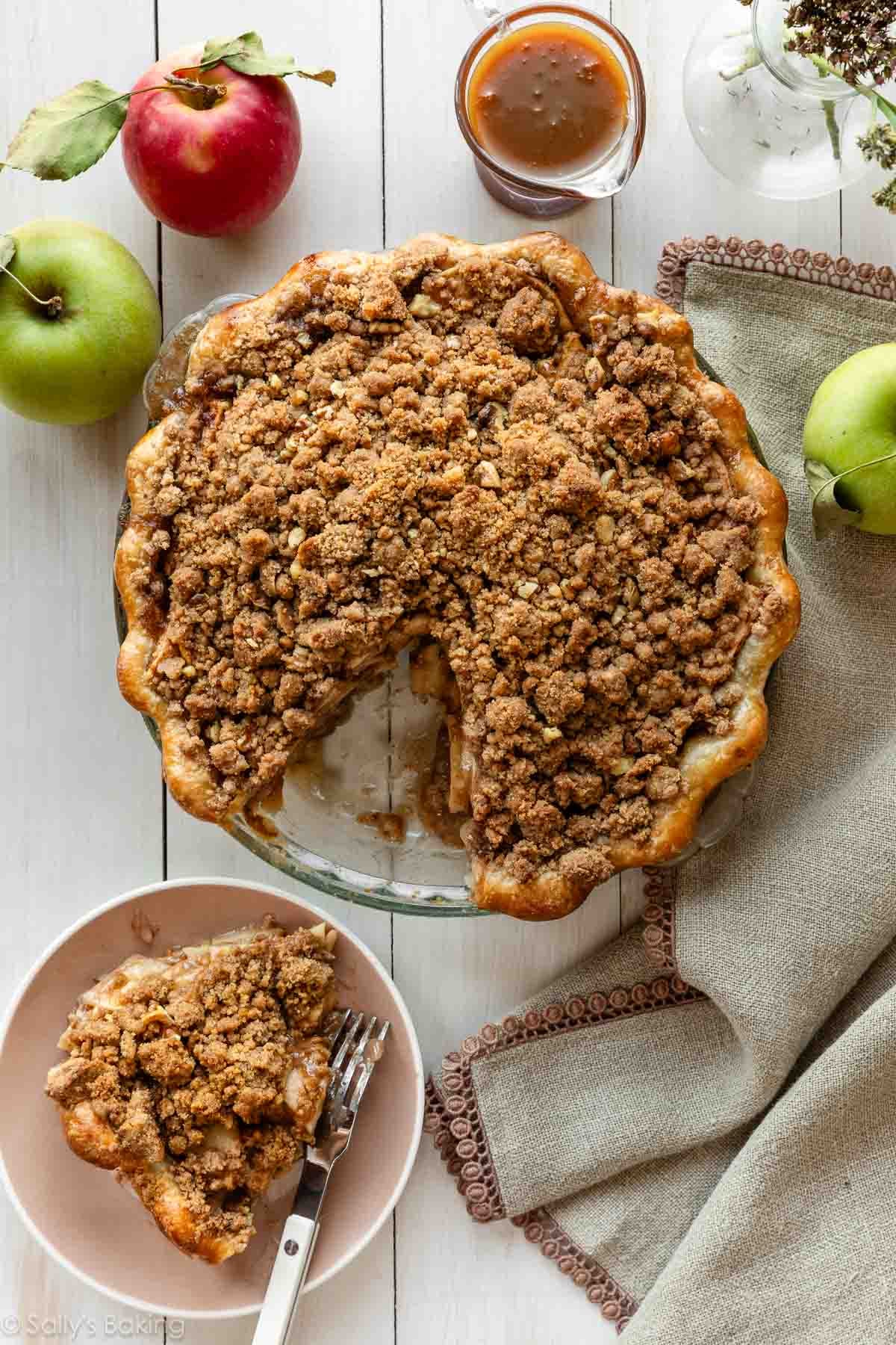 apple crumble pie with slice taken out.