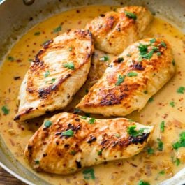 chicken breasts in a skillet with cilantro lime sauce