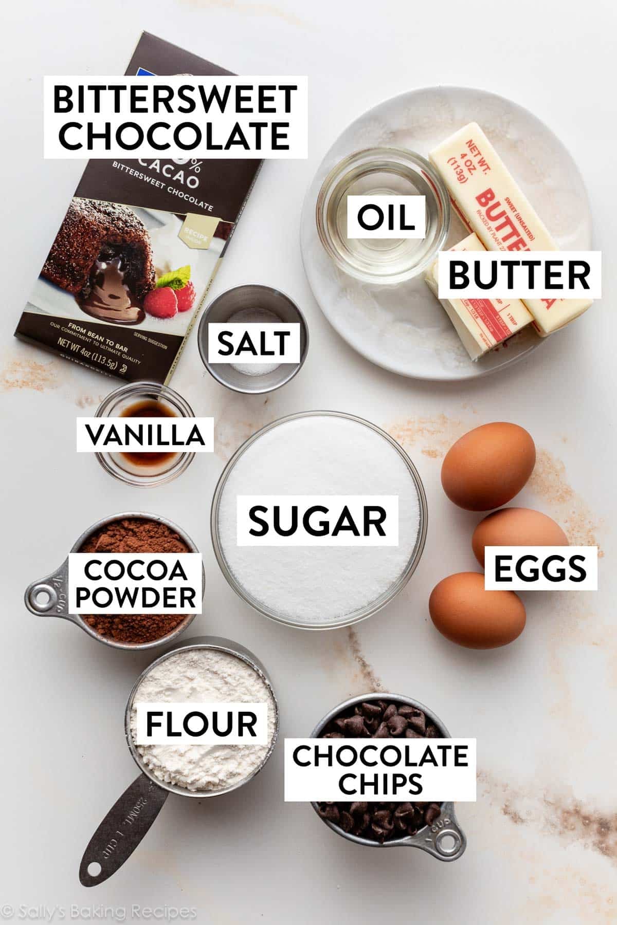 ingredients on counter including butter, chocolate, sugar, eggs, flour, and cocoa powder.