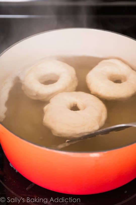 bagels in a water bath in a pot on the stove