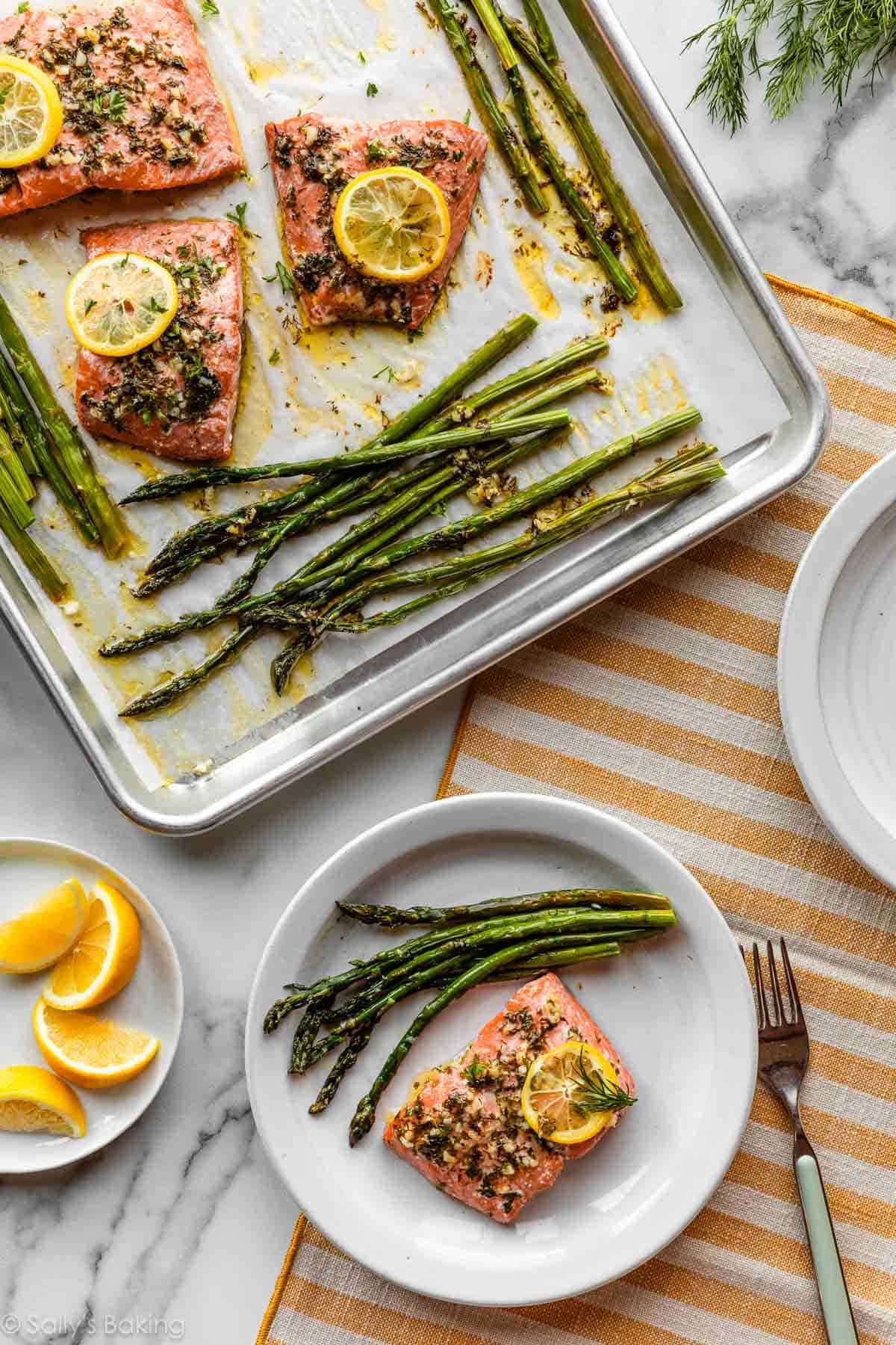 baked lemon salmon on sheet pan and white plate with asparagus.