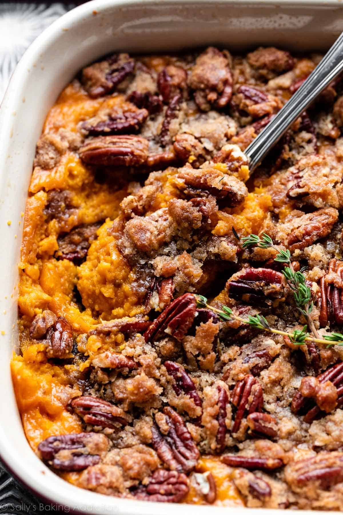 dish of sweet potato casserole with a serving spoon.