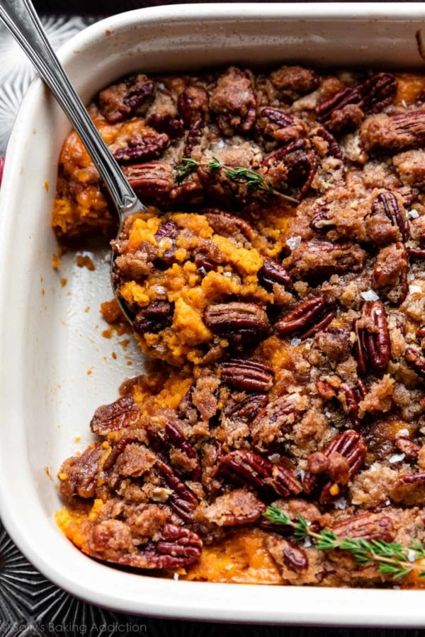 dish of sweet potato casserole with a serving spoon.