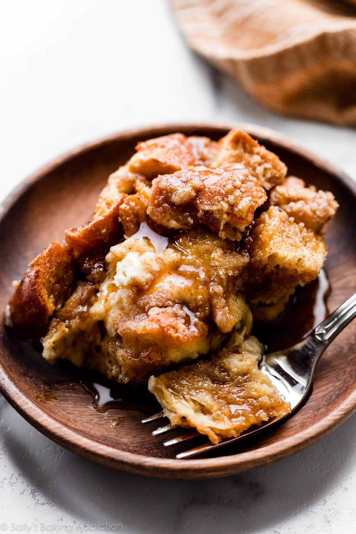 serving of French toast casserole on wood plate