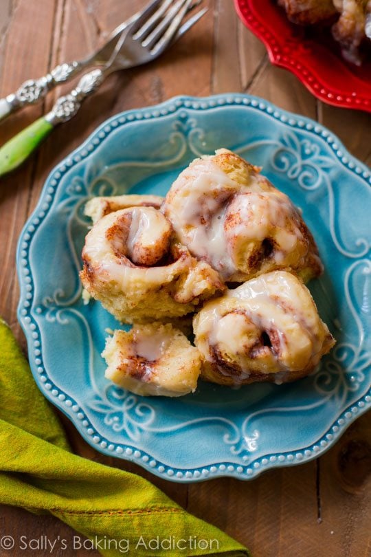 cinnamon rolls with maple icing on a blue plate