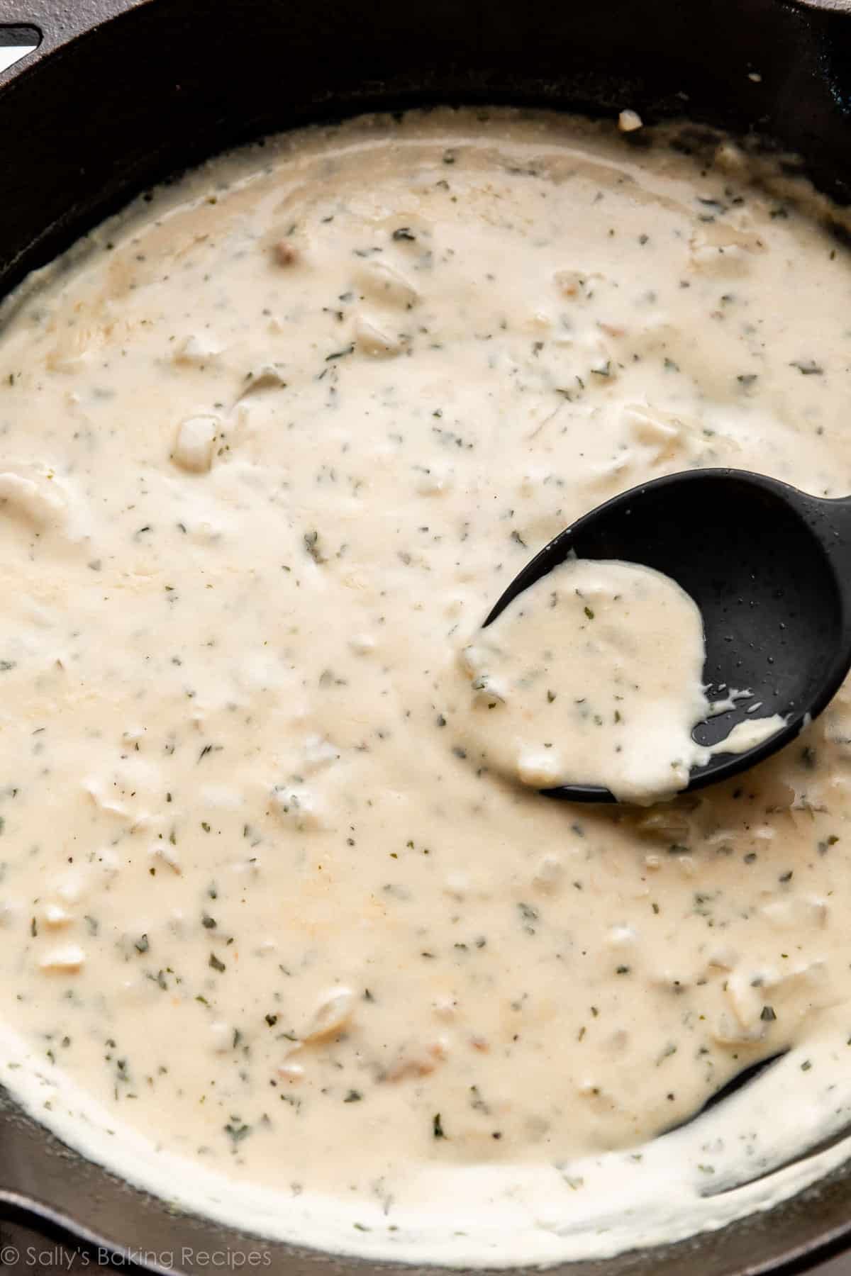 cream garlic sauce with parsley in cast iron skillet.