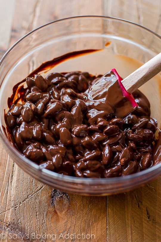 melted chocolate and almonds combined in a glass bowl
