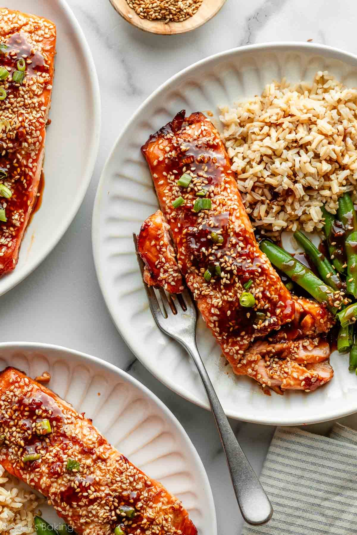 maple sesame salmon with green beans and rice on plates.