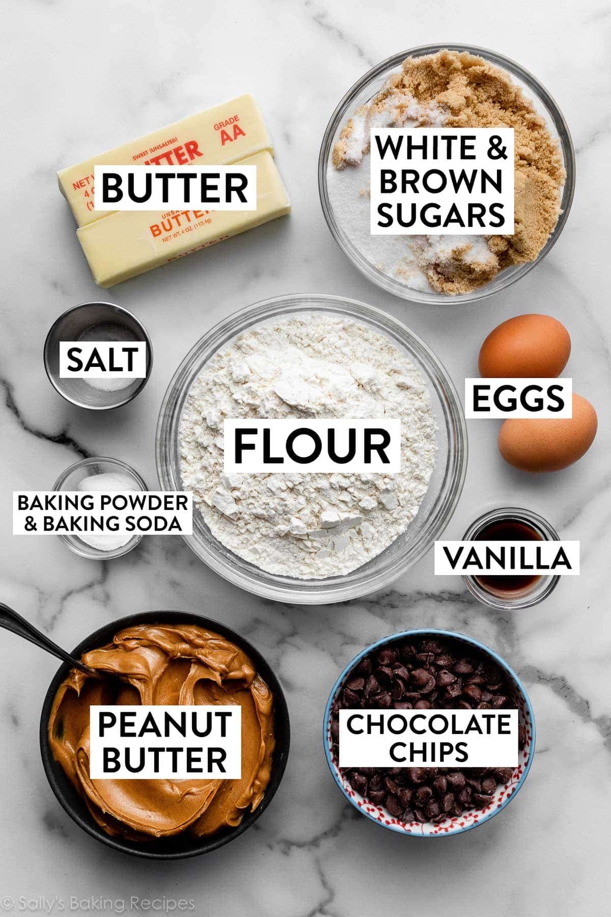 ingredients on counter including flour, eggs, chocolate chips, 2 sticks of butter, and sugars.