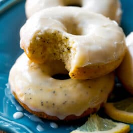 lemon poppy seed donuts on a blue plate