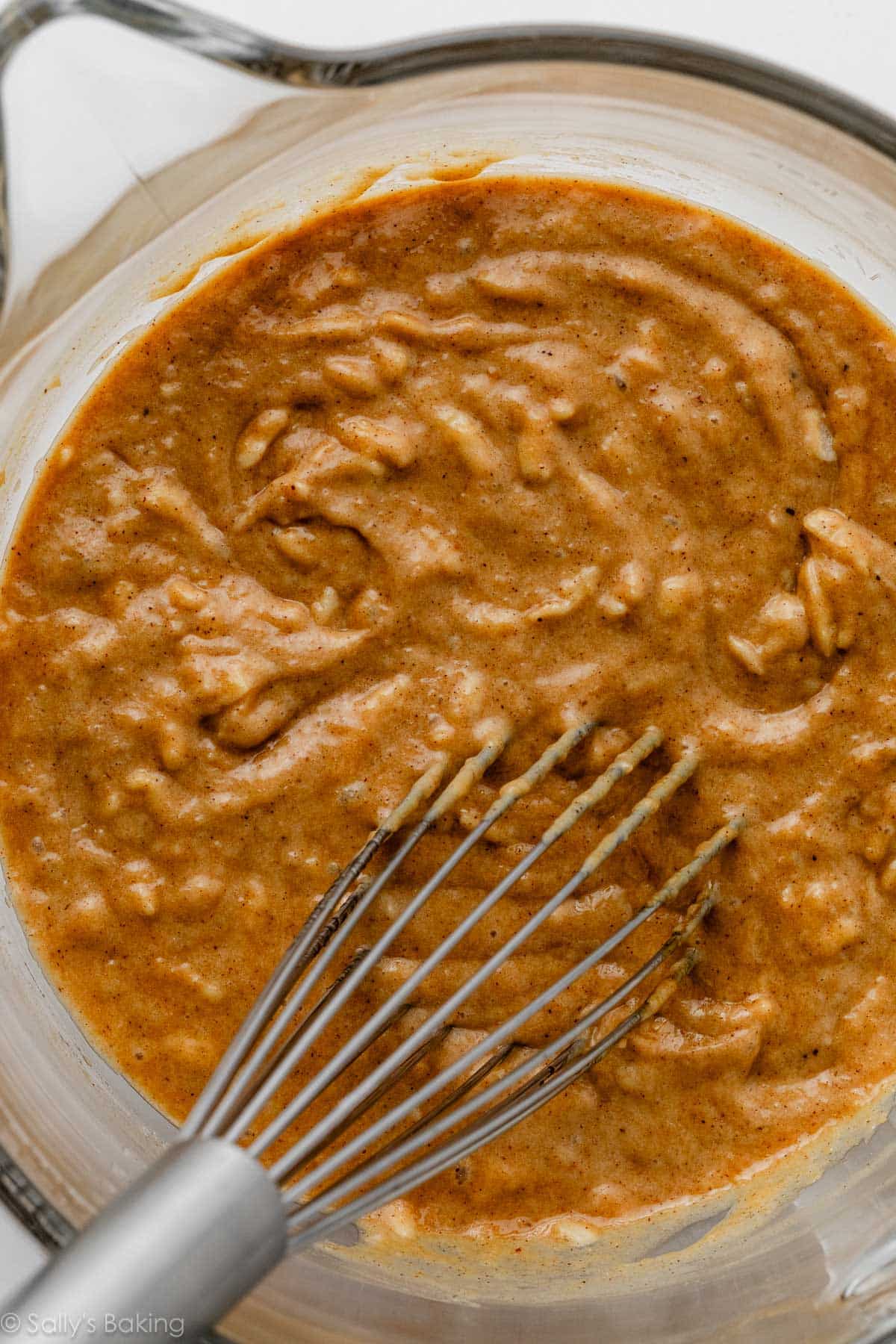 spice batter in glass bowl with whisk.