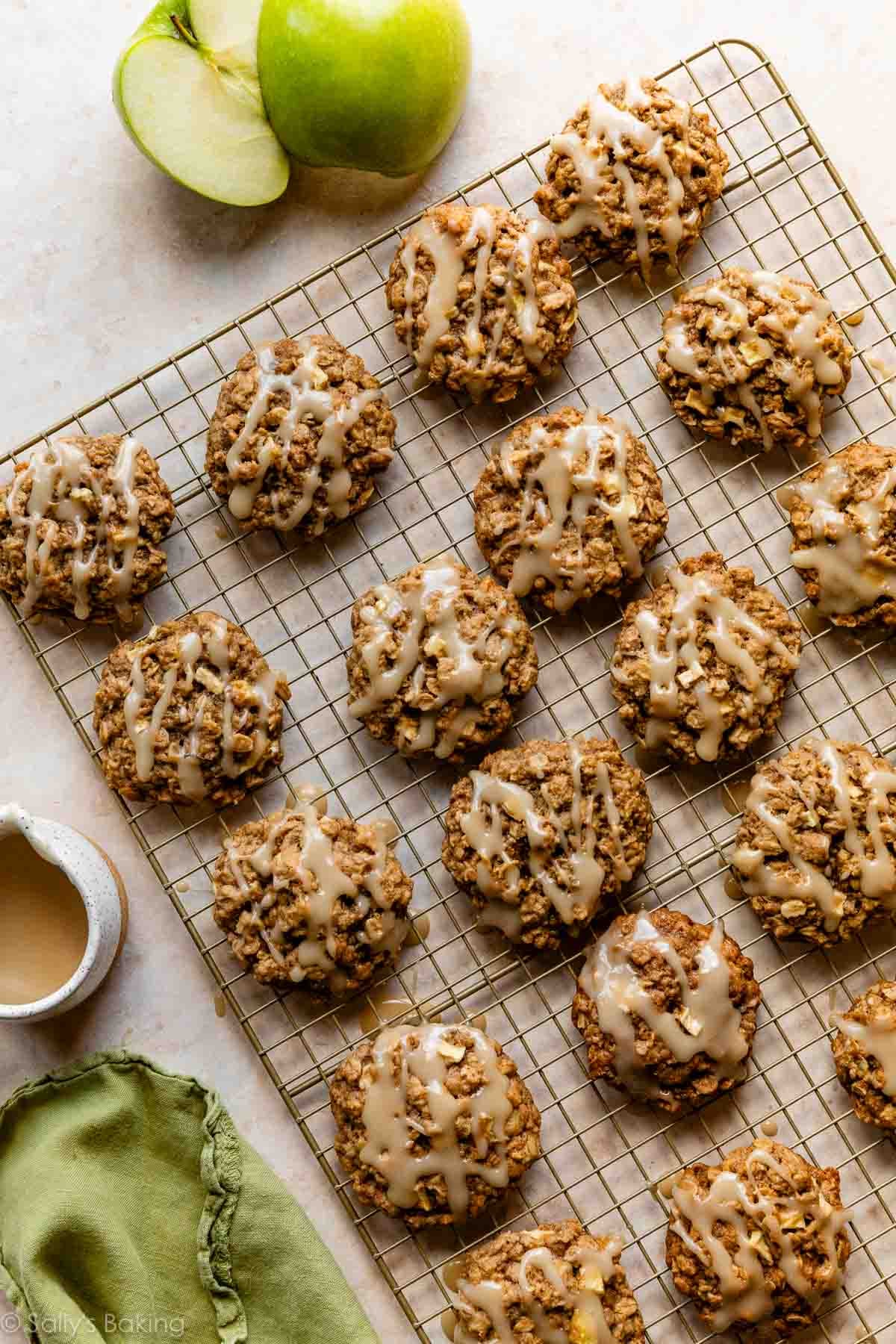 apple cookies on golden cooling rack with a Granny Smith apple next to it.