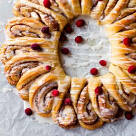 overhead image of cinnamon roll wreath with vanilla icing
