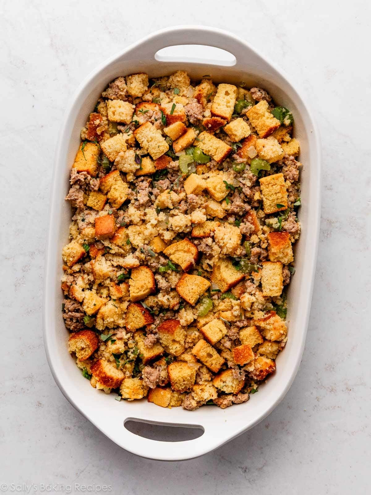 cornbread stuffing in white dish before baking.