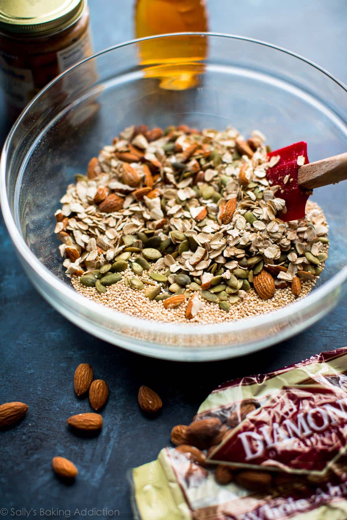 dry ingredients for snack bars in a glass bowl with a spatula