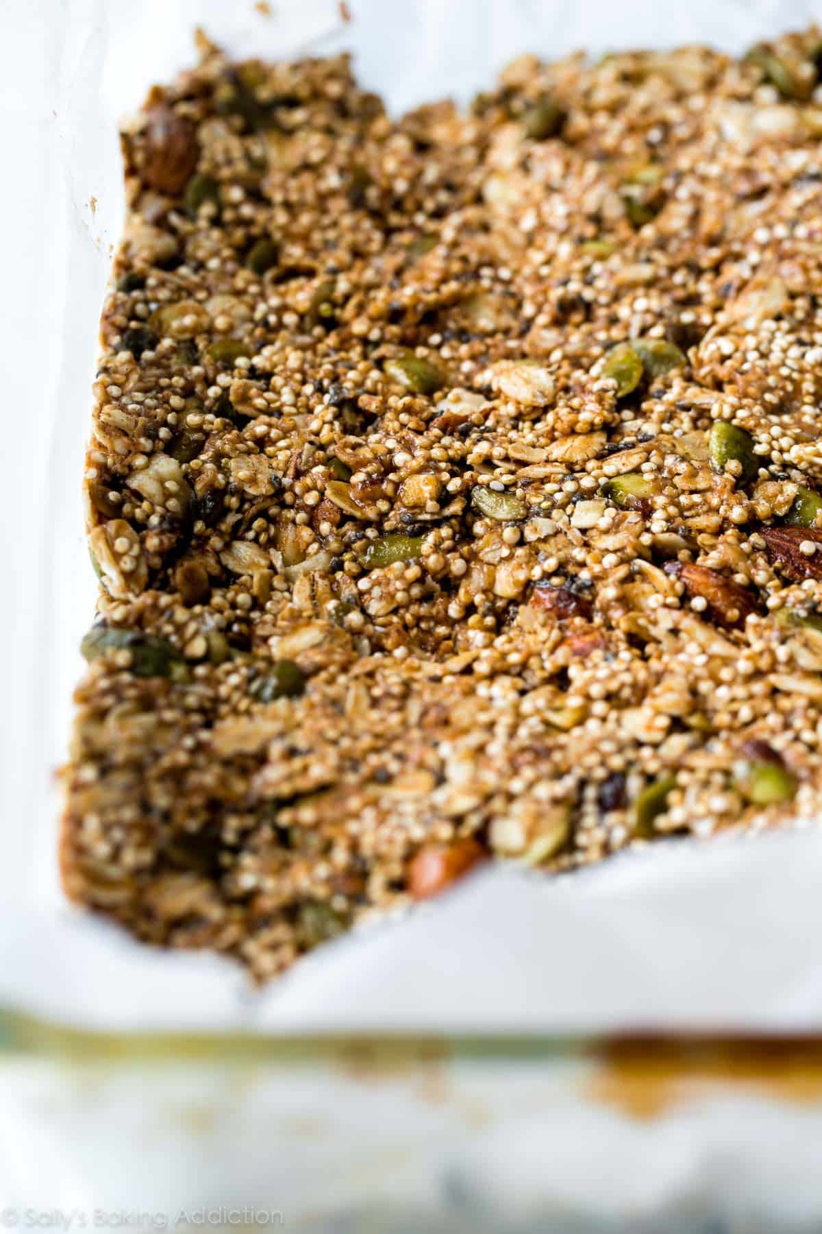 snack bar mixture in a pan lined with parchment paper